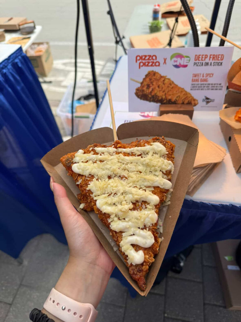 Crispy deep-fried pizza slice on a stick at CNE 2025 Toronto food fair